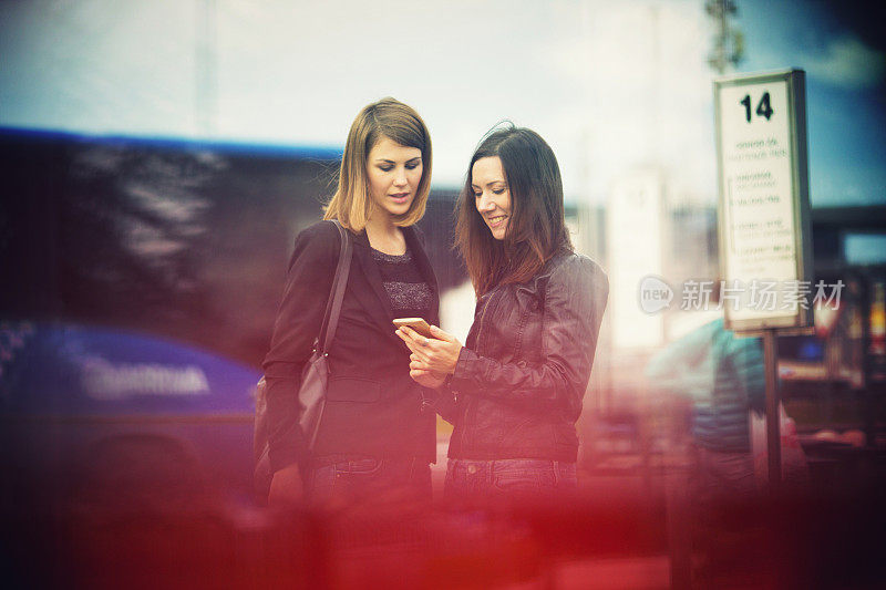 Young women waiting on the bus station